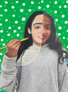 Young artist drawing half of their face over a self-photo using pastel during Art Class in South Austin, blending abstract and personal expression