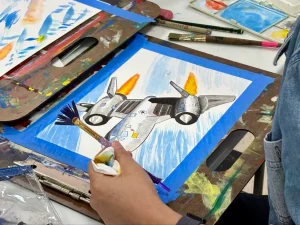 Student drawing a detailed, fast-looking jet during Art Class in Round Rock, showcasing motion and precision in design