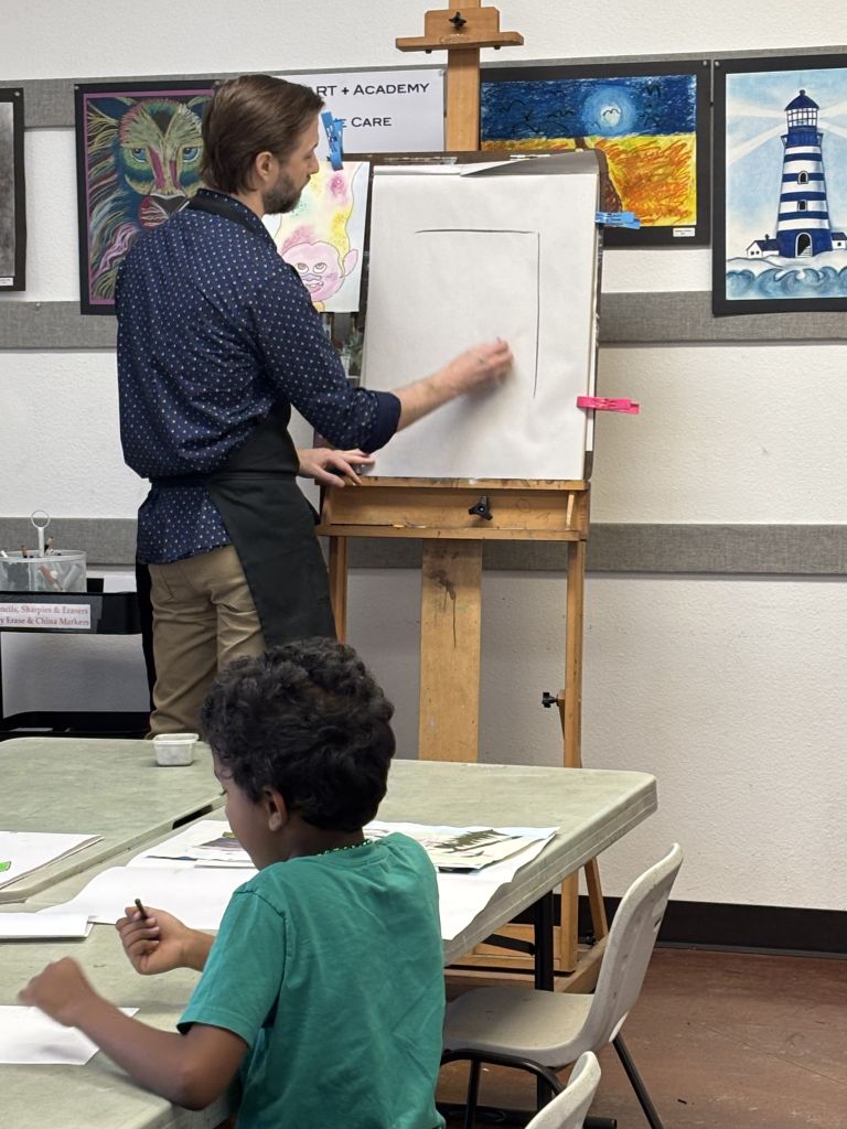 Mr. Jason Art Teacher demonstrating a class