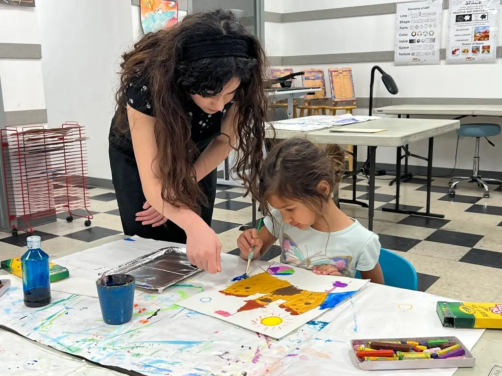 Ms. Naseem demonstrating art techniques