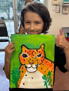 Child showing an early-stage tiger painting during Art Class in Avery Ranch, reflecting a creative starting point