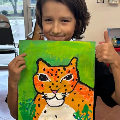 Child showing an early-stage tiger painting during Art Class in Avery Ranch, reflecting a creative starting point